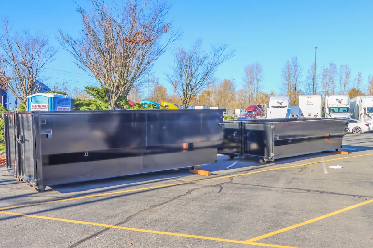 Professional dumpster rental service with roll-off container on residential driveway in Scappoose